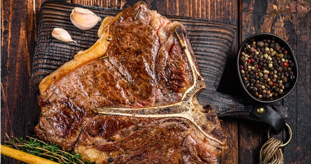 GRILLED PORTERHOUSE STEAK WITH GARLIC CONFIT